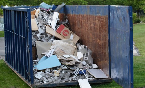 Workers loading bulky items into a van during a mid-sized house clearance